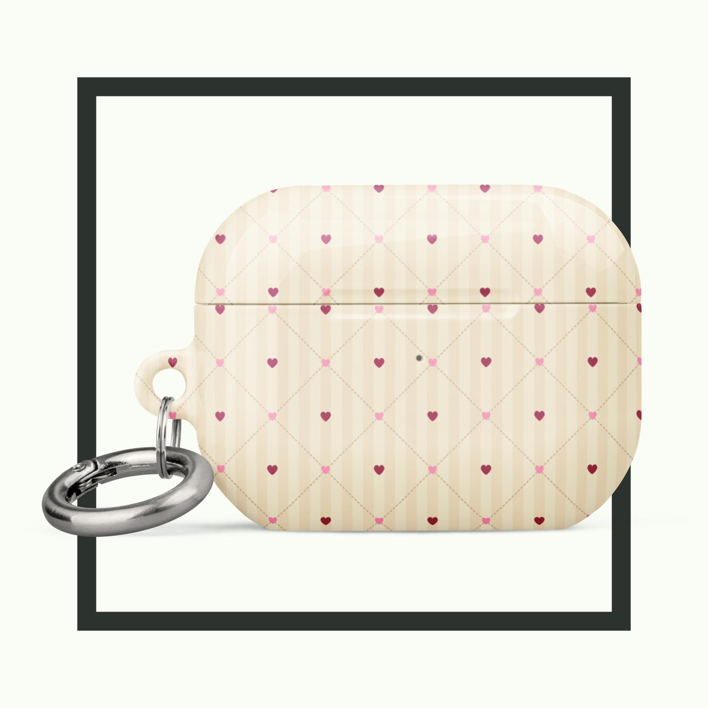 An elegant AirPods® case with a soft beige background and a delicate heart lattice pattern. The case includes a metal carabiner for convenience and provides stylish, impact-absorbing protection. Perfect for timeless charm and functionality!