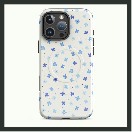 A MagSafe® tough iPhone® case featuring a delicate design of scattered blue forget-me-not flowers on a white background. This dual-layer case combines elegant simplicity with durable protection and MagSafe® compatibility. Perfect for a stylish and functional look!