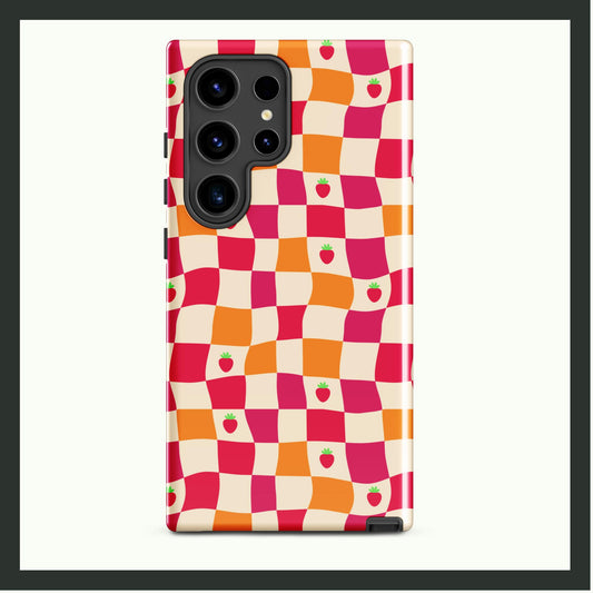 A tough Samsung® phone case with a wavy checkerboard design in pink, orange, and cream, accented with cute strawberry illustrations. This dual-layer case provides durable protection and whimsical style, perfect for everyday use!